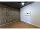 Bedroom with exposed concrete wall and ceiling fan at 400 W Peachtree Nw St # 2314, Atlanta, GA 30308