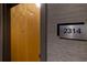 Apartment entry with wood door and numbered plaque at 400 W Peachtree Nw St # 2314, Atlanta, GA 30308