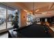 Game room features a pool table, comfortable seating, and large windows at 400 W Peachtree Nw St # 2314, Atlanta, GA 30308