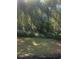 Wooded backyard with lush greenery and grass at 4356 Housworth Dr, Stonecrest, GA 30038