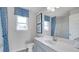 Clean bathroom with gray vanity and blue shower curtain at 1678 Lacebark Elm Way Way, Lawrenceville, GA 30045