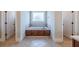 Bathroom with soaking tub and tile flooring at 158 Watkins Glen Dr, Mcdonough, GA 30252
