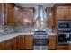 Modern kitchen featuring stainless steel appliances and wood cabinetry at 158 Watkins Glen Dr, Mcdonough, GA 30252
