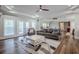 Open living area with hardwood floors, multiple seating areas and access to other rooms at 158 Watkins Glen Dr, Mcdonough, GA 30252