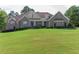 Brick home with a large lawn and 3 car garage at 158 Watkins Glen Dr, Mcdonough, GA 30252