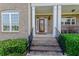 Front door entry with brick steps and landscaping at 158 Watkins Glen Dr, Mcdonough, GA 30252