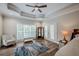 Bright bedroom featuring hardwood floors, large windows, and access to a deck at 158 Watkins Glen Dr, Mcdonough, GA 30252