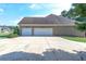 Three-car garage with a large driveway at 158 Watkins Glen Dr, Mcdonough, GA 30252