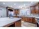 Island kitchen with white quartz countertops and dark wood cabinets at 158 Watkins Glen Dr, Mcdonough, GA 30252