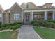 Front entrance with steps leading to a porch with rocking chairs at 158 Watkins Glen Dr, Mcdonough, GA 30252
