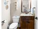 Small bathroom with granite countertop, wood vanity, and decorative accents at 510 Church St, Buford, GA 30518