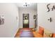 Bright entryway with hardwood floors, a bench, and access to stairs at 510 Church St, Buford, GA 30518