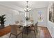 Formal dining room featuring hardwood floors and a chandelier at 435 St Annes Pl, Covington, GA 30016