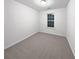 Bright bedroom with neutral carpeting and large window at 709 Celeste Sw Ln, Atlanta, GA 30331