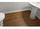 Simple half bathroom with pedestal sink and wood-look flooring at 709 Celeste Sw Ln, Atlanta, GA 30331