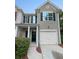 Two story home with attached garage and manicured landscaping at 709 Celeste Sw Ln, Atlanta, GA 30331