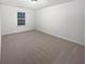 Bright bedroom with neutral carpet and a window at 709 Celeste Sw Ln, Atlanta, GA 30331