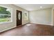 Living room with hardwood floors and a dark brown door at 1847 Ridgeland Dr, Decatur, GA 30032