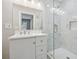 White vanity, marble shower, and updated bathroom at 1847 Ridgeland Dr, Decatur, GA 30032