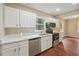 Modern kitchen with white cabinets, quartz countertops, and stainless steel appliances at 1847 Ridgeland Dr, Decatur, GA 30032