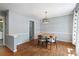 Bright dining room with hardwood floors and a wood table set at 873 Hearthstone Dr, Stone Mountain, GA 30083