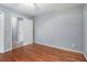 Well-lit bedroom with hardwood floors and access to a hallway at 873 Hearthstone Dr, Stone Mountain, GA 30083