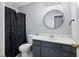 Clean bathroom with dark vanity and a shower/tub combo at 873 Hearthstone Dr, Stone Mountain, GA 30083