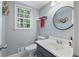 Updated bathroom with a gray vanity and a round mirror at 873 Hearthstone Dr, Stone Mountain, GA 30083