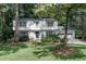 Two-story house with white brick, black door, and landscaped yard at 873 Hearthstone Dr, Stone Mountain, GA 30083