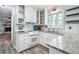 Updated kitchen with white cabinets, granite counters, and wood floors at 873 Hearthstone Dr, Stone Mountain, GA 30083