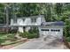 Two-story house with white brick, double garage, and landscaped yard at 873 Hearthstone Dr, Stone Mountain, GA 30083