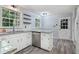 Updated kitchen with white cabinets, granite counters, and wood floors at 873 Hearthstone Dr, Stone Mountain, GA 30083
