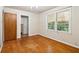 Hardwood floor bedroom with large window and access to the bathroom at 1272 Breezy Ne Ln, Atlanta, GA 30329