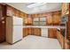 Kitchen with wood cabinets, appliances, and tile floor at 1272 Breezy Ne Ln, Atlanta, GA 30329