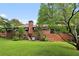 Back of brick house, showcasing a large yard at 1272 Breezy Ne Ln, Atlanta, GA 30329