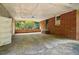 Covered carport with concrete flooring and storage area at 1272 Breezy Ne Ln, Atlanta, GA 30329
