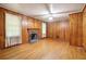 Living room with hardwood floors, wood walls and a fireplace at 1272 Breezy Ne Ln, Atlanta, GA 30329