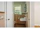 Small bathroom with pink tile and a pedestal sink at 1272 Breezy Ne Ln, Atlanta, GA 30329