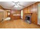 Spacious living room featuring hardwood floors, wood paneling and a brick fireplace at 1272 Breezy Ne Ln, Atlanta, GA 30329
