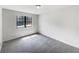 Bright bedroom with grey carpet and a window at 6902 Babbling Brook Dr, Rex, GA 30273