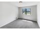 Simple bedroom with grey carpet and window at 6902 Babbling Brook Dr, Rex, GA 30273