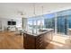 Open concept kitchen with island and city views from large windows at 45 Ivan Allen Jr. Nw Blvd # 2501, Atlanta, GA 30308