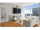 Spacious living area with large TV, hardwood floors and city views at 45 Ivan Allen Jr. Nw Blvd # 2501, Atlanta, GA 30308