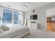 Primary bedroom with city views, modern furniture, and ensuite access at 45 Ivan Allen Jr. Nw Blvd # 2501, Atlanta, GA 30308
