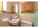 Small bathroom with beige tile and a pedestal sink at 1645 Highpoint Rd, Snellville, GA 30078