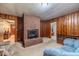 Living room featuring a brick fireplace and wood paneling at 1645 Highpoint Rd, Snellville, GA 30078