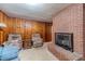 Spacious living room with brick fireplace and wood paneling at 1645 Highpoint Rd, Snellville, GA 30078