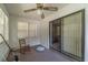 Sunroom with sliding glass door, ceiling fan, and hardwood floors at 1645 Highpoint Rd, Snellville, GA 30078