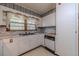 Kitchen features white cabinets, dishwasher, and built-in oven at 1645 Highpoint Rd, Snellville, GA 30078