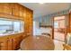 Eat-in kitchen with wood cabinets and a round table at 1645 Highpoint Rd, Snellville, GA 30078